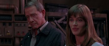 Movie still from “Leviathan” (1989), directed by George P. Cosmatos – A man and a woman standing next to each other; Close Up shot, Over the shoulder angle