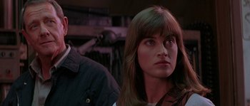 Movie still from “Leviathan” (1989), directed by George P. Cosmatos – A person with long hair; Close Up shot, Over the shoulder angle