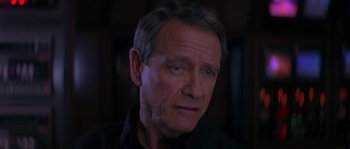 Movie still from “Leviathan” (1989), directed by George P. Cosmatos – An older man with blue eyes stares at the camera; Close Up shot, Over the shoulder angle