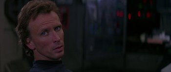 Movie still from “Leviathan” (1989), directed by George P. Cosmatos – A person wearing a black shirt; Close Up shot, Over the shoulder angle