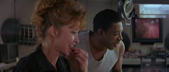 Movie still from “Leviathan” (1989), directed by George P. Cosmatos – A woman and a man sitting next to each other; Close Up shot, Low angle