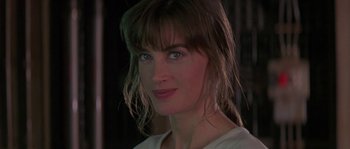 Movie still from “Leviathan” (1989), directed by George P. Cosmatos – A woman's face in a dark room; Close Up shot, Over the shoulder angle