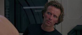 Movie still from “Leviathan” (1989), directed by George P. Cosmatos – A person wearing a black shirt; Close Up shot, Over the shoulder angle