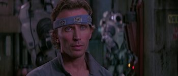 Movie still from “Leviathan” (1989), directed by George P. Cosmatos – A person wearing a head band; Close Up shot, Over the shoulder angle