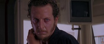 Movie still from “Leviathan” (1989), directed by George P. Cosmatos – A person wearing a black shirt; Close Up shot, Low angle