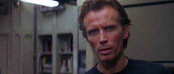 Movie still from “Leviathan” (1989), directed by George P. Cosmatos – A person wearing a black t - shirt; Close Up shot, Low angle