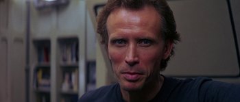 Movie still from “Leviathan” (1989), directed by George P. Cosmatos – A person wearing a black t - shirt; Close Up shot, Low angle