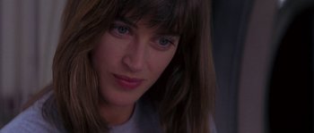 Movie still from “Leviathan” (1989), directed by George P. Cosmatos – A woman's face in a white shirt; Close Up shot, Over the shoulder angle