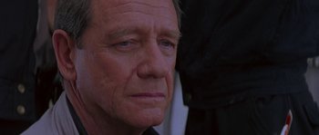 Movie still from “Leviathan” (1989), directed by George P. Cosmatos – An older man with blue eyes looking into the distance; Close Up shot, Over the shoulder angle