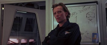 Movie still from “Leviathan” (1989), directed by George P. Cosmatos – A person wearing a jacket; Close Up shot, Over the shoulder angle