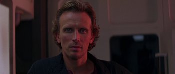 Movie still from “Leviathan” (1989), directed by George P. Cosmatos – A person with long hair; Close Up shot, Over the shoulder angle