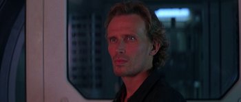 Movie still from “Leviathan” (1989), directed by George P. Cosmatos – A person wearing a black shirt; Close Up shot, Low angle