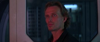 Movie still from “Leviathan” (1989), directed by George P. Cosmatos – A person wearing a black shirt; Close Up shot, Low angle