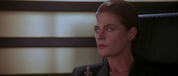 Movie still from “Leviathan” (1989), directed by George P. Cosmatos – A person wearing a suit and tie; Close Up shot, Low angle