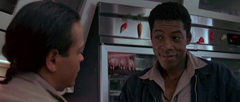 Movie still from “Leviathan” (1989), directed by George P. Cosmatos – Two men are talking in front of a refrigerator; Close Up shot, Over the shoulder angle