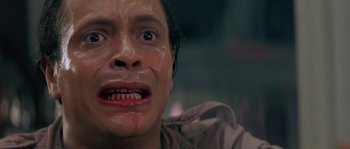 Movie still from “Leviathan” (1989), directed by George P. Cosmatos – A man's face covered in blood; Close Up shot, Low angle