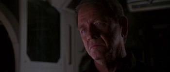 Movie still from “Leviathan” (1989), directed by George P. Cosmatos – An older man with blue eyes stares at the camera; Close Up shot, Over the shoulder angle