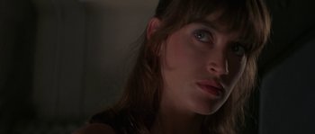 Movie still from “Leviathan” (1989), directed by George P. Cosmatos – A woman's face in the dark; Close Up shot, Over the shoulder angle