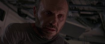 Movie still from “Leviathan” (1989), directed by George P. Cosmatos – A person looking at the camera; Close Up shot, Low angle