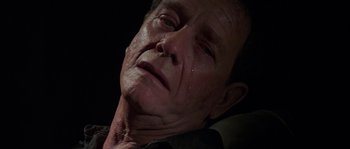 Movie still from “Leviathan” (1989), directed by George P. Cosmatos – An old man with a sad look on his face; Close Up shot, High angle