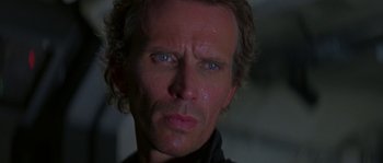 Movie still from “Leviathan” (1989), directed by George P. Cosmatos – A man's face in the dark; Close Up shot, Low angle