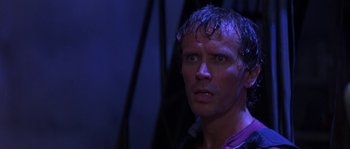 Movie still from “Leviathan” (1989), directed by George P. Cosmatos – A person with wet hair; Close Up shot, Low angle