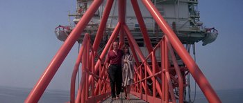Movie still from “Leviathan” (1989), directed by George P. Cosmatos – A man and a woman are standing on a bridge; Wide shot, Low angle