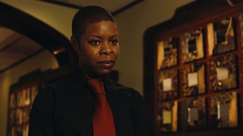 A woman wearing a black shirt and a red tie