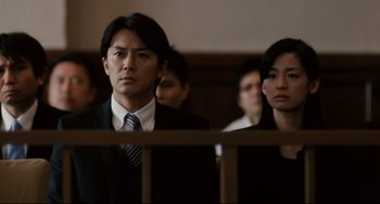 Movie still from “Like Father, Like Son” (2013), directed by Kore-eda Hirokazu – A man and a woman in a court room; Close Up shot, Low angle