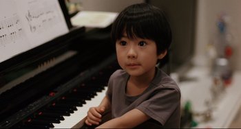 Movie still from “Like Father, Like Son” (2013), directed by Kore-eda Hirokazu – A little boy sitting in front of a piano; Close Up shot, High angle