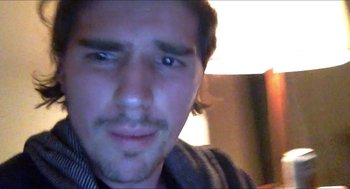 Movie still from “Like Me” (2017), directed by Robert Mockler – A man's face in the dark; Close Up shot, Over the shoulder angle