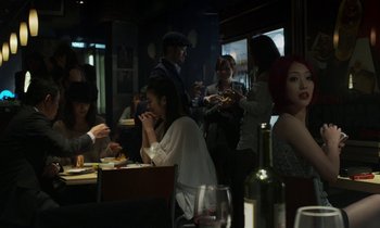 Movie still from “Like Someone in Love” (2012), directed by Abbas Kiarostami – A group of people sitting at a table eating food; Medium shot, Over the shoulder angle