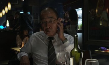 Movie still from “Like Someone in Love” (2012), directed by Abbas Kiarostami – An older man sitting in front of a bottle of wine; Close Up shot, Over the shoulder angle