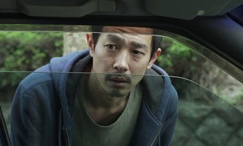 Movie still from “Like Someone in Love” (2012), directed by Abbas Kiarostami – A man looking out of the window of a car; Close Up shot, High angle
