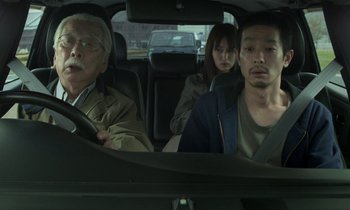 Movie still from “Like Someone in Love” (2012), directed by Abbas Kiarostami – A group of people in the back seat of a car; Medium shot, Over the shoulder angle