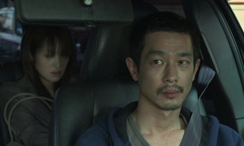 Movie still from “Like Someone in Love” (2012), directed by Abbas Kiarostami – A man and a woman sitting in a car; Close Up shot, Over the shoulder angle