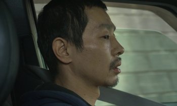 Movie still from “Like Someone in Love” (2012), directed by Abbas Kiarostami – A person in a car; Close Up shot, Low angle