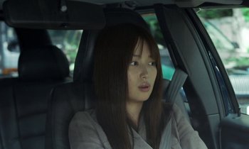Movie still from “Like Someone in Love” (2012), directed by Abbas Kiarostami – A woman sitting in the back seat of a car; Close Up shot, Over the shoulder angle