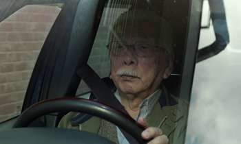 Movie still from “Like Someone in Love” (2012), directed by Abbas Kiarostami – An old man driving a car with a hat on; Close Up shot, Low angle