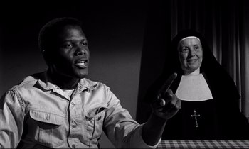 Movie still from “Lilies of the Field” (1963), directed by Ralph Nelson – A black and white photo of a man and a nun; Close Up shot, Over the shoulder angle