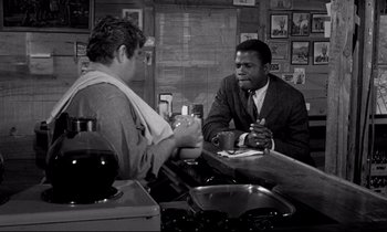 Movie still from “Lilies of the Field” (1963), directed by Ralph Nelson – Two men sitting at a bar talking to each other; Medium shot, Over the shoulder angle