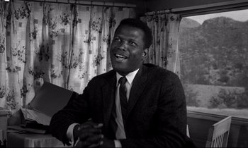 Movie still from “Lilies of the Field” (1963), directed by Ralph Nelson – A black and white photo of a man in a suit; Close Up shot, Low angle