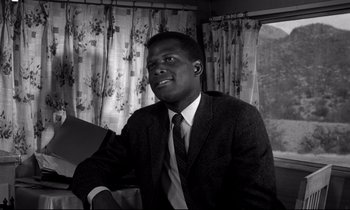 Movie still from “Lilies of the Field” (1963), directed by Ralph Nelson – A black and white photo of a man wearing a suit and tie; Close Up shot, Low angle