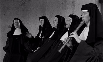 Movie still from “Lilies of the Field” (1963), directed by Ralph Nelson – A group of nuns sitting next to each other; Medium shot, High angle