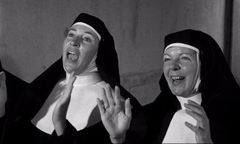 Movie still from “Lilies of the Field” (1963), directed by Ralph Nelson – Two women dressed in nun's clothes and smiling; Medium shot, Low angle