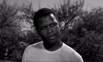Movie still from “Lilies of the Field” (1963), directed by Ralph Nelson – A black and white photo of a man in a white t - shirt; Close Up shot, Low angle