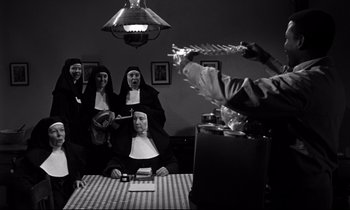 Movie still from “Lilies of the Field” (1963), directed by Ralph Nelson – A group of people dressed up as nuns; Medium shot, High angle