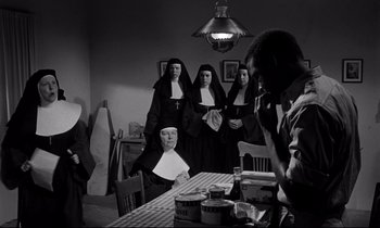 Movie still from “Lilies of the Field” (1963), directed by Ralph Nelson – A group of nuns standing around a table; Medium shot, Low angle