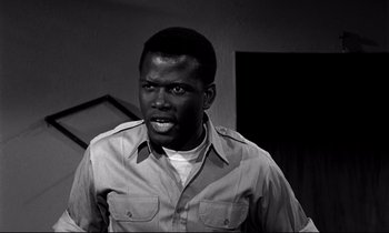Movie still from “Lilies of the Field” (1963), directed by Ralph Nelson – A black and white photo of a man in a shirt; Close Up shot, Low angle