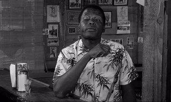 Movie still from “Lilies of the Field” (1963), directed by Ralph Nelson – A black and white photo of a man in a hawaiian shirt; Medium shot, Low angle